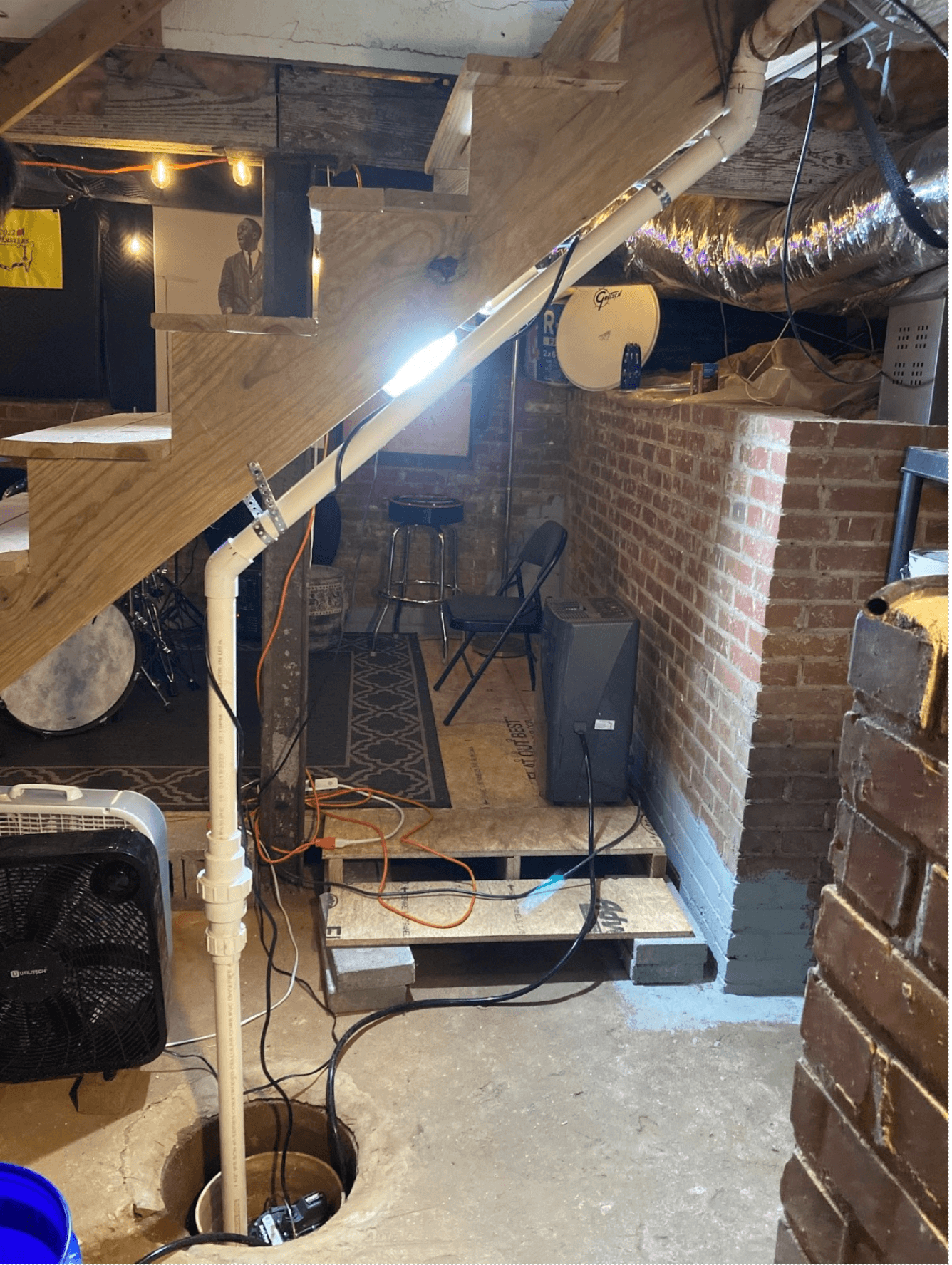 A sump pump system installed under basement stairs in Spartanburg